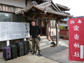 宝当神社の云われの看板の前でバックを並べて記念撮影